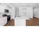 Bright, modern kitchen features white cabinets, stainless steel appliances and an island at 1119 Lockhart Way, Douglasville, GA 30135