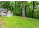 Expansive backyard with mature trees, offering privacy and a serene outdoor space at 1342 Old Johnson Ferry Ne Rd, Brookhaven, GA 30319