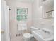Bright bathroom with white tiles, a window, and classic fixtures. A clean and simple design at 1342 Old Johnson Ferry Ne Rd, Brookhaven, GA 30319