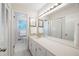 Well-lit bathroom features a large mirror, white cabinets, and charming decorative prints at 1342 Old Johnson Ferry Ne Rd, Brookhaven, GA 30319
