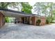 Brick home featuring a covered carport, connecting indoor and outdoor spaces seamlessly at 1342 Old Johnson Ferry Ne Rd, Brookhaven, GA 30319
