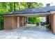 Spacious carport area attached to the brick home, providing covered parking and storage at 1342 Old Johnson Ferry Ne Rd, Brookhaven, GA 30319