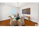 Classic dining room with modern decor, hardwood floors, and a glass table with chairs at 1342 Old Johnson Ferry Ne Rd, Brookhaven, GA 30319