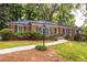 Landscaped front yard with a brick facade and dark shutters for a classic look at 1342 Old Johnson Ferry Ne Rd, Brookhaven, GA 30319