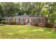 Charming brick home with manicured lawn and mature trees offering great curb appeal at 1342 Old Johnson Ferry Ne Rd, Brookhaven, GA 30319