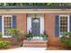 Close-up of the home's entrance, showcasing the stylish door, brickwork, and landscaping at 1342 Old Johnson Ferry Ne Rd, Brookhaven, GA 30319