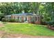 Beautifully landscaped front yard with a classic brick home and well-manicured shrubs at 1342 Old Johnson Ferry Ne Rd, Brookhaven, GA 30319