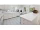 Bright kitchen featuring white cabinetry, tiled floors, and modern appliances for a clean look at 1342 Old Johnson Ferry Ne Rd, Brookhaven, GA 30319