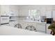 Charming kitchen features white cabinets, tiled backsplash, and modern appliances at 1342 Old Johnson Ferry Ne Rd, Brookhaven, GA 30319