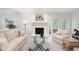 Inviting living room featuring a painted fireplace and double French doors at 1342 Old Johnson Ferry Ne Rd, Brookhaven, GA 30319