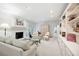 Bright living room with fireplace, double French doors, and custom shelving at 1342 Old Johnson Ferry Ne Rd, Brookhaven, GA 30319