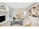 Inviting living room featuring a white-painted fireplace and double French doors at 1342 Old Johnson Ferry Ne Rd, Brookhaven, GA 30319