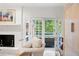 Bright living room boasts a white-painted brick fireplace, access to the deck, and unique decor at 1342 Old Johnson Ferry Ne Rd, Brookhaven, GA 30319