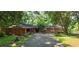 Charming single-story home with a long driveway and a wooded front yard at 1717 Briarbend Ct, Stone Mountain, GA 30088