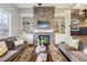 Living room featuring a stacked stone fireplace with custom built-ins and hardwood floors at 255 Southerland Ne Ter # 207, Atlanta, GA 30307