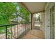 View of the greenery and the complex from the balcony with concrete floor and black metal railing at 3655 Habersham Road Northeast Ne Rd # B249, Atlanta, GA 30305