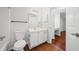 A well-lit bathroom showing a white toilet, cabinets and sink at 3655 Habersham Road Northeast Ne Rd # B249, Atlanta, GA 30305