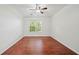 Bright, minimalist bedroom with a large window and warm wood flooring creates a serene atmosphere at 3655 Habersham Road Northeast Ne Rd # B249, Atlanta, GA 30305