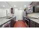 A modern kitchen design with stainless steel appliances, dark wood cabinets, and wood floors at 3655 Habersham Road Northeast Ne Rd # B249, Atlanta, GA 30305