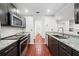 A well-lit, updated kitchen with dark cabinets, stainless steel appliances, and granite countertops at 3655 Habersham Road Northeast Ne Rd # B249, Atlanta, GA 30305