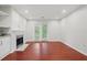 Bright living room with hardwood floors, fireplace, and sliding glass doors to the outside at 3655 Habersham Road Northeast Ne Rd # B249, Atlanta, GA 30305