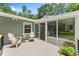Relaxing back porch with outdoor seating and view into screened in porch; perfect for entertaining or relaxation at 6875 Sunny Brook Lane Northeast, Sandy Springs, GA 30328