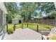 View of the back yard from the back porch, featuring a storage shed and a small fire pit at 6875 Sunny Brook Lane Northeast, Sandy Springs, GA 30328