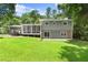 Expansive backyard with a screened porch and a deck, ideal for outdoor entertaining and relaxation at 6875 Sunny Brook Lane Northeast, Sandy Springs, GA 30328