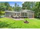 Expansive backyard with a deck, sunroom, and fire pit, ideal for outdoor living and entertaining at 6875 Sunny Brook Lane Northeast, Sandy Springs, GA 30328