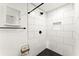 Modern bathroom featuring a walk-in shower with stylish black fixtures and herringbone tile flooring at 6875 Sunny Brook Lane Northeast, Sandy Springs, GA 30328
