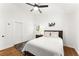 Cozy bedroom with a ceiling fan, a large closet, and a unique drum set art piece at 6875 Sunny Brook Lane Northeast, Sandy Springs, GA 30328