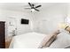 Comfortable bedroom with a ceiling fan, a flat-screen TV, closet, and hardwood floors at 6875 Sunny Brook Lane Northeast, Sandy Springs, GA 30328