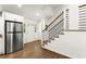 Inviting entryway with stainless steel fridge, wood floors, modern staircase and plenty of natural light at 6875 Sunny Brook Lane Northeast, Sandy Springs, GA 30328