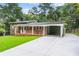 Beautiful two-story brick home with a covered carport, manicured lawn, and inviting curb appeal at 6875 Sunny Brook Lane Northeast, Sandy Springs, GA 30328