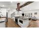 Open concept kitchen features stainless appliances, stone counters, bar seating, and easy access to the living room at 6875 Sunny Brook Lane Northeast, Sandy Springs, GA 30328