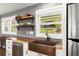 Up-close view of kitchen detailing butcher block counters, copper sink, open shelving, stainless dishwasher and refrigerator at 6875 Sunny Brook Lane Northeast, Sandy Springs, GA 30328
