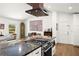 Open concept kitchen featuring stainless appliances, an island cooktop, and easy access to the living room at 6875 Sunny Brook Lane Northeast, Sandy Springs, GA 30328