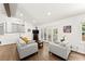 Bright living room features hardwood floors, neutral paint, and access to the outdoor living space through french doors at 6875 Sunny Brook Lane Northeast, Sandy Springs, GA 30328