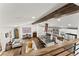 Open-concept living space with a kitchen island, wood beams, and an abundance of natural light at 6875 Sunny Brook Lane Northeast, Sandy Springs, GA 30328