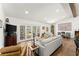 Bright living room featuring hardwood floors, access to the sunroom through french doors, and neutral paint at 6875 Sunny Brook Lane Northeast, Sandy Springs, GA 30328