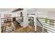 Bright open-concept living space with wood floors, beamed ceilings, and a modern staircase at 6875 Sunny Brook Lane Northeast, Sandy Springs, GA 30328