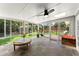 Bright sunroom featuring tile flooring, ceiling fan, skylight, and sliding doors to a back deck with greenery at 6875 Sunny Brook Lane Northeast, Sandy Springs, GA 30328
