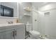 Modern bathroom featuring a glass-enclosed shower, gray vanity, and subway tile at 875 Soaring Cir, Marietta, GA 30062
