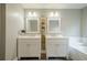 Bathroom featuring double vanity sinks, mirrors, and white cabinets with marble countertops at 875 Soaring Cir, Marietta, GA 30062