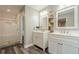 Bathroom featuring double vanity sinks, mirrors, open shelving, and a separate shower at 875 Soaring Cir, Marietta, GA 30062
