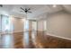 Bedroom showcasing a tray ceiling, dark hardwood floors, and two windows providing plenty of natural light at 875 Soaring Cir, Marietta, GA 30062