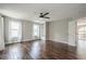 Bedroom featuring dark hardwood flooring, a ceiling fan, built-in shelving, and windows with white curtains at 875 Soaring Cir, Marietta, GA 30062