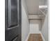 A closet with a dark door and wire rack storage above a small door at 875 Soaring Cir, Marietta, GA 30062