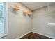 Walk-in closet featuring custom shelving, dark hardwood floors, and a window for natural light at 875 Soaring Cir, Marietta, GA 30062