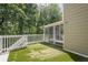 Artificial turf lines the outdoor deck area with a railing around the parameter at 875 Soaring Cir, Marietta, GA 30062